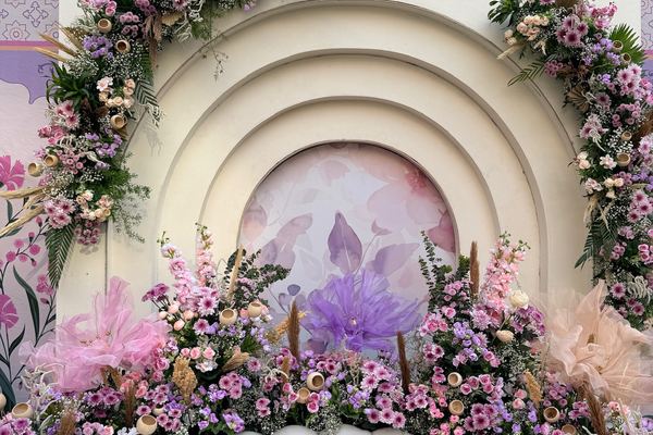 Blush arch couple seating at Siddharth Banquets